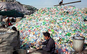Workers sort waste materials in a recycling plant in China.