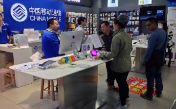 Various types of mobile phones are being sold in China Mobile’s store at the Link City shopping mall in Shenzhen.