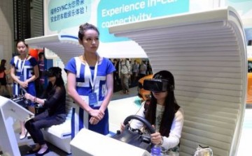 Visitors try one of the featured products at the 2015 International Consumer Electronics Show (CES) Asia in Shanghai.