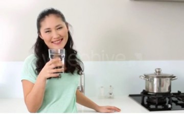 A Woman Drinking Glass of Water