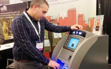 A developer of China's first ATM with facial recognition feature tests the machine in public.