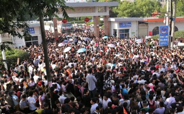 More than ten thousand parents and local residents in Anhui Province wave goodbye to the students, wishing them good luck for the exams on June 5, 2015.