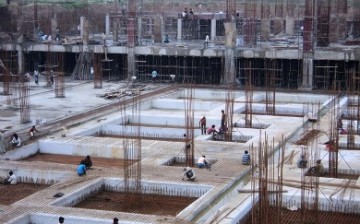 Workers lay out the foundation for a building being constructed in China.