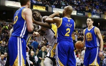 Indiana Pacers center Roy Hibbert (2nd L) shoves Golden State Warriors forward David Lee (L) while Warriors guards Jarrett Jack (2) and Klay Thompson (R) stand near the play during their NBA basketball game in Indianapolis, Indiana February 26, 2013.