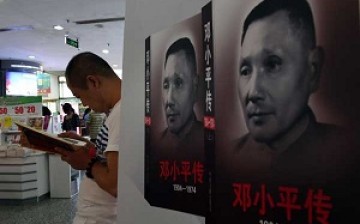 A man reads a copy of the new biography of former Chinese Leader Deng Xiaoping in a bookstore in China.