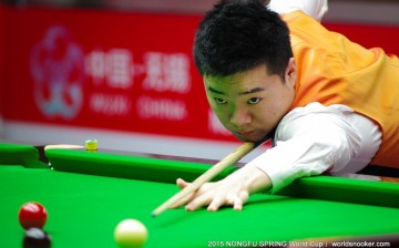 China's Ding Junhui steadies his snooker cue during the Nongfu Spring World Cup in Wuxi, Jiangsu Province, on Wednesday, June 17, 2015. 