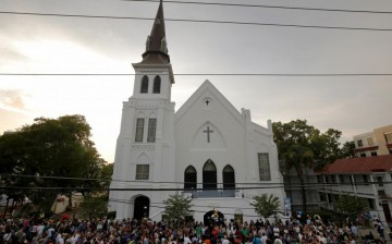 A crowd gathers outside the Emanuel African Methodist Episcopal Church following a prayer vigil nearby in Charleston, South Carolina, June 19, 2015. 