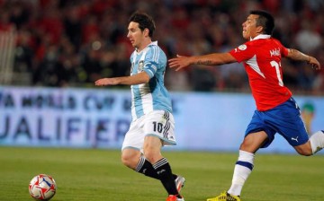 Chile's Gary Medel (R) tries to stop Argentina's Lionel Messi during a World Cup qualifying match in 2012.