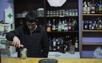A young man prepares a cocktail at a 