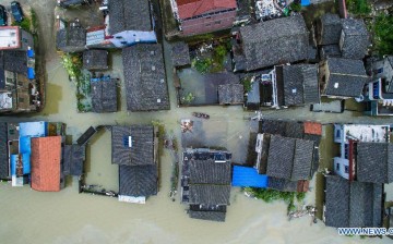 Houses flooded in Chejiu village of Yuyao, east China's Zhejiang Province. China's meteorological authority on Sunday downgraded the alert for Typhoon Chan-Hom from red to orange as it is set to weaken on its way to move northeast. 