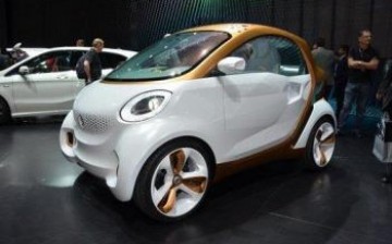 People look at a smart car on display in Guangzhou Auto Show. 