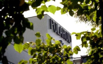 The world headquarters of Polaroid Corporation is framed by trees inCambridge, Massachusetts October 10, 2001.