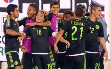 Mexico midfielder Andres Guardado (#18) celebrates with teammates after kicking a penalty kick to score a goal against Costa Rica.