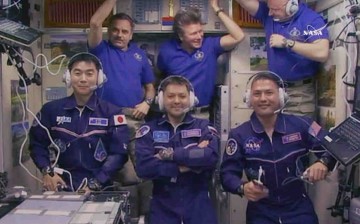 All six Expedition 44 crew members gathered inside the Zvezda service module for a crew greeting ceremony with new crewmates (front row from left) Kimiya Yui, Oleg Kononenko and Kjell Lindgren. In the back from left are Mikhail Kornienko, Gennady Padalka 