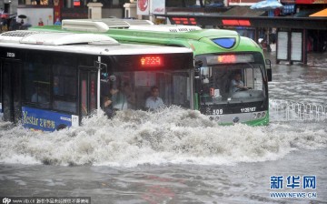 Heavy rainstorm turns buses into boats in Wuhan, capital city of central China's Hubei Province, on July 23, 2015.