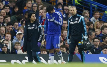 Chelsea forward Diego Costa walking off the pitch with an injured hamstring.