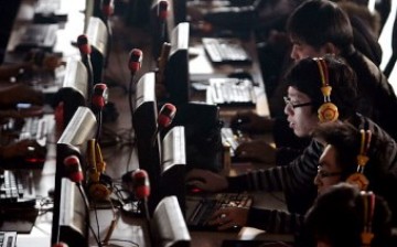 A group of Chinese young people surfing the Web at an Internet shop.