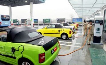 Workers recharge electric cars at a charging station, the first in Yangzhou, east China's Jiangsu Province.