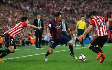 Barcelona's Lionel Messi (middle) works on two Athletic Bilbao defenders.