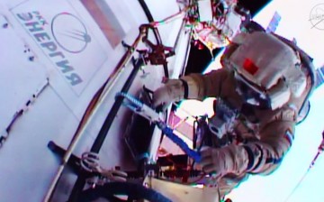 Cosmonaut Mikhail Kornienko is seen working outside the International Space Station in a Russian Orlan spacesuit. 