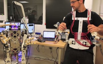  PhD student Joao Ramos demonstrates the Balance Feedback Interface, a system that enables an operator to control the balance and movements of a robot, through an exoskeleton and motorized platform. 
