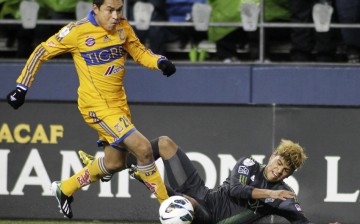 UANL midfielder Albert Acosta (L) runs over Seattle Sounders defender DeAndre Yedlin in a file photo.