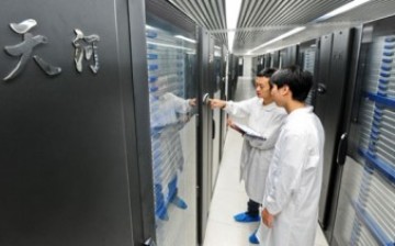 Staff members collect data from computers containing Tianhe-1A.