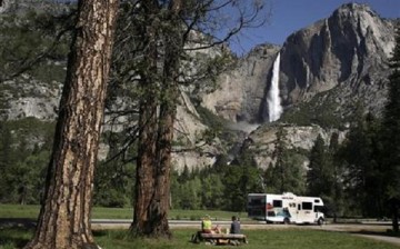 A family has a picnic in view of Upper Yosemite Falls in Yosemite National Park, California.