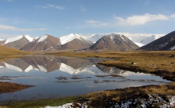  A lake mirrors some fresh-snow covered glaciers in the Teskey Ala-Too, Kyrgyzstan. Yet the appearance is deceiving: Glaciers in the Tien Shan are loosing mass at a rapid pace 