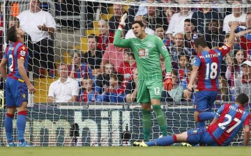 Crystal Palace’s Damien Delaney (#27) sits dejected after scoring an own goal against Arsenal.