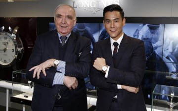 Eddie Peng shows off his Longines watch as he poses beside Longines president Walter von Känel in Hong Kong.