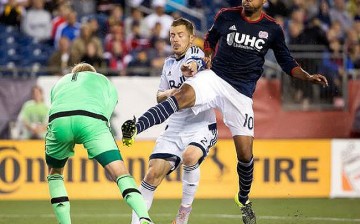 Vancouver Whitecaps defender Jordan Harvey (middle) assists his goalie David Ousted on defense.