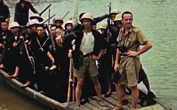 Ray Scott rides a wooden barge together with some Chinese natives.