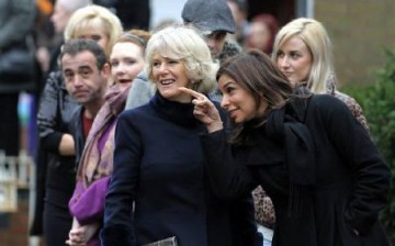 Britain's Camilla, Duchess of Cornwall (3rd R) speaks to cast member Shobna Gulati during a visit to the television set of 