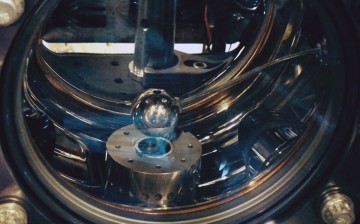 The vacuum chamber of the atom interferometer contains a one-inch diameter aluminum sphere. If chameleons exist, cesium atoms would fall toward the sphere with a slightly greater acceleration than their gravitational attraction would predict.