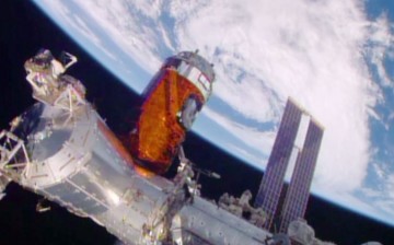 Japan’s “Kounotori” resupply ship is installed to the Harmony module. 