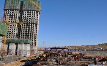 Laborers work at the construction site of a low-cost housing project in Ordos City in China’s Inner Mongolia Region.
