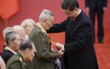 Chinese President Xi Jinping bestows medals to veterans of World War II in a ceremony held at the Great Hall of the People in Beijing.
