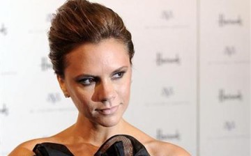 Singer and clothes designer Victoria Beckham poses for photographers during a photocall at Harrods store, to promote the Spring/Summer 2008 collection of her 'dVb' clothing range, London May 15, 2008.