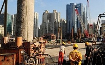 Chinese builders carry out construction in Shanghai as part of the infrastructure projects of the government.