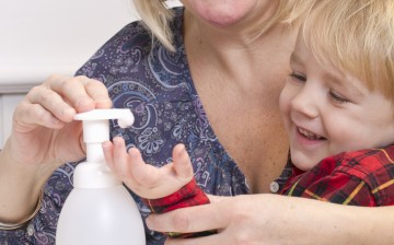 Woman Applying Sanitizer to Child's Hands