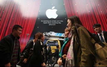 Shoppers walk past an Apple Store at Hysan Place in Causeway Bay, Hong Kong.