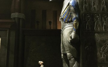 Bryan Singer is looking at an Egyptian god statue at the set of his 