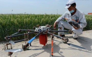 A technician prepares a drone to spray insecticide in Shijiazhuang, north China's Hebei Province, in this May 19, 2015 photo. 