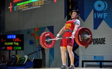 Huang Ting lifts with all her might as she participates in the 2015 IWF Youth World Championships held in Lima, Peru.