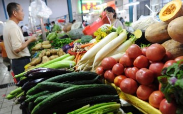 People buy vegetables in a market at Hefei, Anhui Province, Sept. 11, 2010.