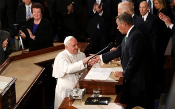 United States House Speaker John Boehner shakes hands with Pope Francis.