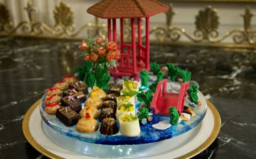 A dessert display features a Chinese-style pavilion and bridge, which was made by hand with chocolate.