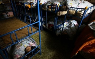 Some left-behind children sleep in dorms in their kindergartens because their parents leave them to work in the city.