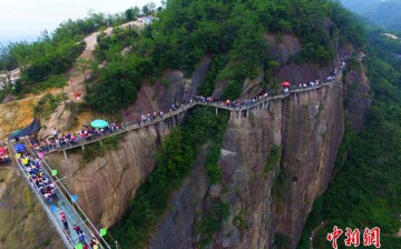 Thousands of people on and near the all-glass bridge, which is located in Pingjiang County, in central China's Hunan Province. 